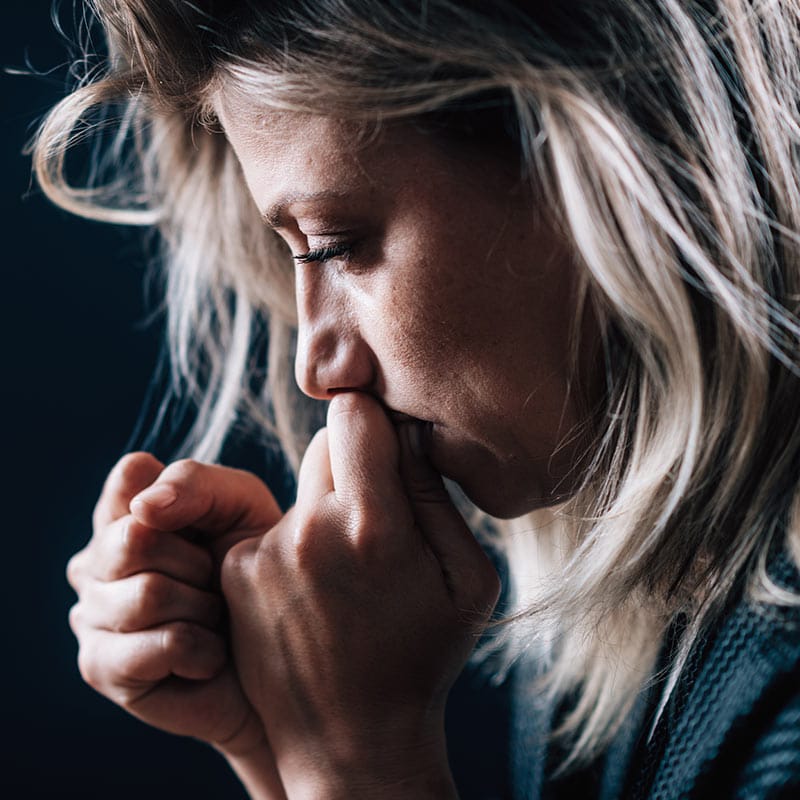 A woman lost in thought, grieving